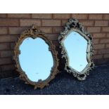Two gilt framed oval mirrors,