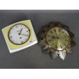 A pottery cased Hettich wall clock in yellow and white,