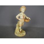 Royal Worcester - A figurine of a boy carrying a basket, shape # 1388,