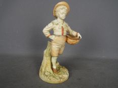 Royal Worcester - A figurine of a boy carrying a basket, shape # 1388,
