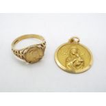 A 9ct gold ring with inset panel depicting the Madonna (panel stamped 9ct verso),