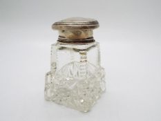 A George V cut glass and silver topped dressing table scent bottle, with stopper,