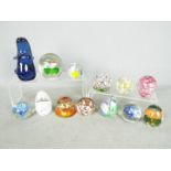 A collection of glass paperweights to include Mdina and similar.