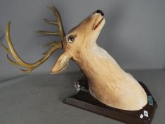 A Buck The Singing Deer animated and musical trophy, with remote,