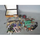 A collection of costume jewellery and similar, brooches, beads, ring and other.