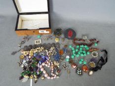 A collection of costume jewellery and similar, brooches, beads, ring and other.