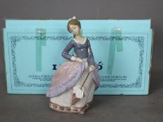 Lladro - A boxed figurine entitled Evita, # 5212, depicting a young lady with a parasol,