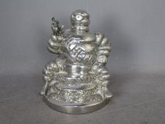 Automobilia - Bibendum: A chrome plated Michelin Man seated on two tyres and holding a spanner,