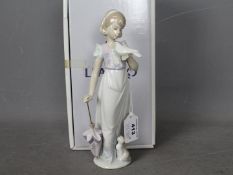 Lladro - A boxed Collectors Society figurine, 1991, entitled Summer Stroll # 7611,