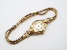 A 9ct gold cased lady's wristwatch on 9ct gold strap, approximately 17 grams all in.
