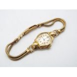 A 9ct gold cased lady's wristwatch on 9ct gold strap, approximately 17 grams all in.