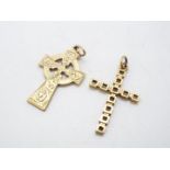 A 9ct gold Celtic cross pendant 2.7 cm x 1.7 cm and a 9ct gold crucifix pendant, approximately 3.