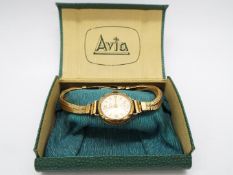 A 9ct gold cased Avia wristwatch on 9ct gold twin strand bracelet (15 cm length),