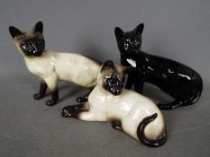 Beswick - Three Beswick cat figurines, largest approximately 16.5 cm (h).