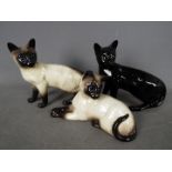 Beswick - Three Beswick cat figurines, largest approximately 16.5 cm (h).