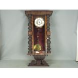A mahogany cased wall clock with pendulum (front glass pane missing)