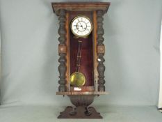 A mahogany cased wall clock with pendulum (front glass pane missing)