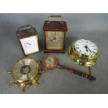 A small collection of clocks and a barometer.