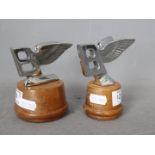 Automobilia - Two Bentley Flying B car mascots, mounted on wooden plinths,