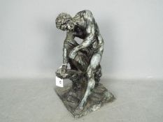 A cast metal sculpture after Edme Dumont depicting Milo of Croton,