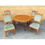 A oak drop leaf table and four upholstered chairs, table approximately 72 cm x 119 cm x 48 cm.