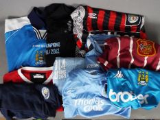 A collection of Manchester City Football Club replica shirts, polo shirts and similar,