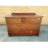 An oak chest of two over two drawers measuring approximately 66 cm x 108 cm x 42 cm