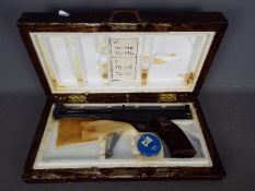 El Gamo 0.177 cal. under lever action target pistol. Marked H12410 in wooden case made in Spain.