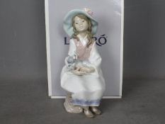 Lladro - A boxed figurine entitled Daydreams, # 6400, depicting a young girl holding a dog,