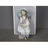 Lladro - A boxed figurine entitled Daydreams, # 6400, depicting a young girl holding a dog,