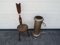 A Belling Champion Heater and a Ben Setter, Totnes spinning stool with Celtic design decoration.