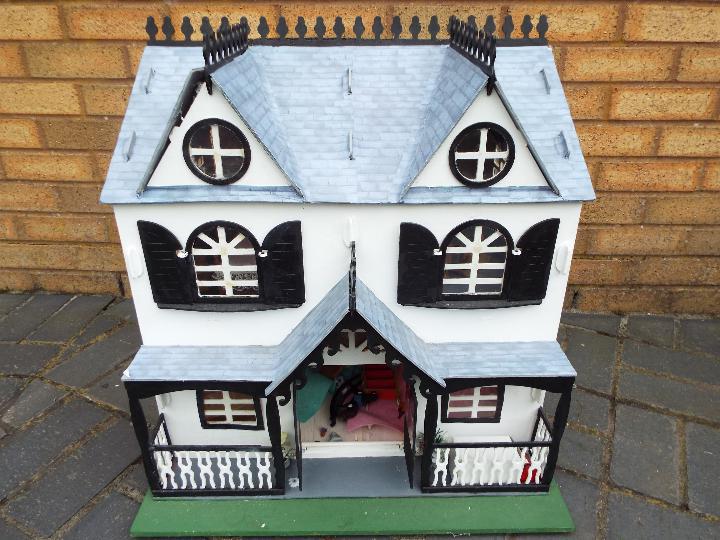 Three scratch built wooden dolls houses. Click on photographs to view each house.