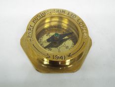 A boxed brass compass by Henry Hughes