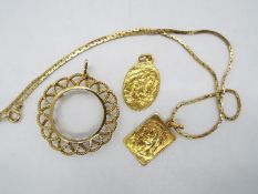 Lot to include two yellow metal religious pendants, one on yellow metal chain (marks unclear,