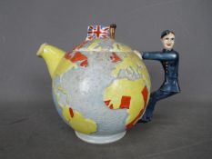 A vintage Empire Ware teapot in the form of a globe depicting the British Empire,