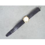 A gentleman's 9ct gold cased wristwatch, the dial signed Freeson, on black leather strap.