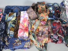 A collection of gentleman's neckties, silk and other and a silk and wool scarf.