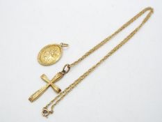 A 9ct gold chain and crucifix pendant, chain 36 cm (l) and a 9ct gold St Christopher medallion,