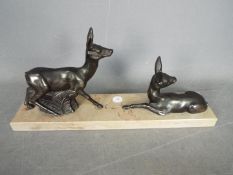 A deer set on a marble plinth,