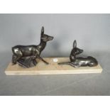 A deer set on a marble plinth,