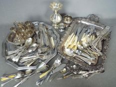 A quantity of loose flatware, plated and stainless with other plated ware.