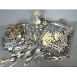 A quantity of loose flatware, plated and stainless with other plated ware.