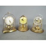 Three miniature anniversary 400-day clocks to include a Schatz 53 model together with two