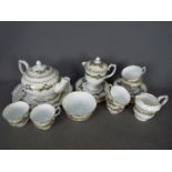 A Crown Staffordshire tea service with floral decoration comprising teapot, milk jug and sugar bowl,
