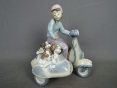 Lladro - A Lladro figural group depicting a boy on a scooter with a sidecar containing three