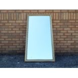 A gilt framed pier mirror measuring approximately 133 cm x 70 cm.