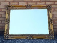 A large bevel edged mirror, approximately 80 cm x 110 cm.