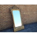 A very large gilt framed wall mirror, the mirror with bevelled edge,