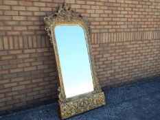 A very large gilt framed wall mirror, the mirror with bevelled edge,