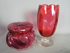 A Cranberry Glass vase 21 cm and an ornate lidded pot 12 cm